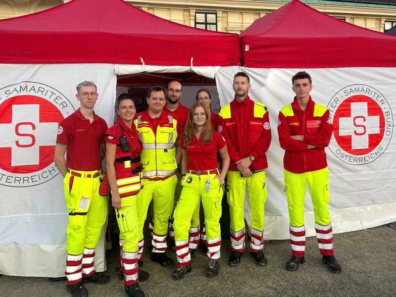 Helmut Steinbrecher with the Samariterbund team in front of an event medical tent